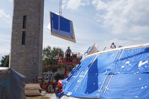  Die vorgefertigten Wandelemente werden eingebaut. Von außen sind sie mit OSB-Platten beplankt und mit Dampfbremse zum Witterungsschutz versehen 