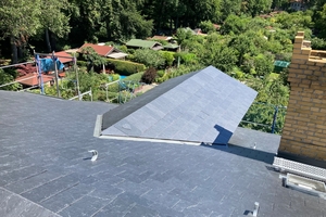  Die alte Dachabdichtung wurde abgetragen und das Dach mit rechteckigen Schiefersteinen neu eingedeckt  