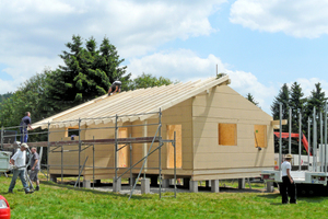  In einem Tag wurde das Holzhaus mit fleißigen Helferinnen und Helfern aufgerichtet 